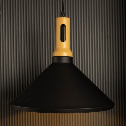 A black wood pendant light switched on against a black background where the warm light shines brightly and the wooden accent contrasts with the dark backdrop.