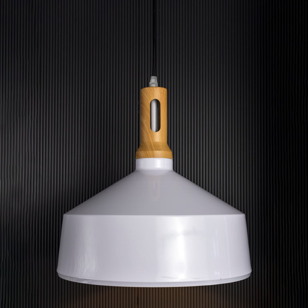 A white pendant light with a wooden top glowing warmly against a deep black background creating a bright contrast that enhances its modern shape.