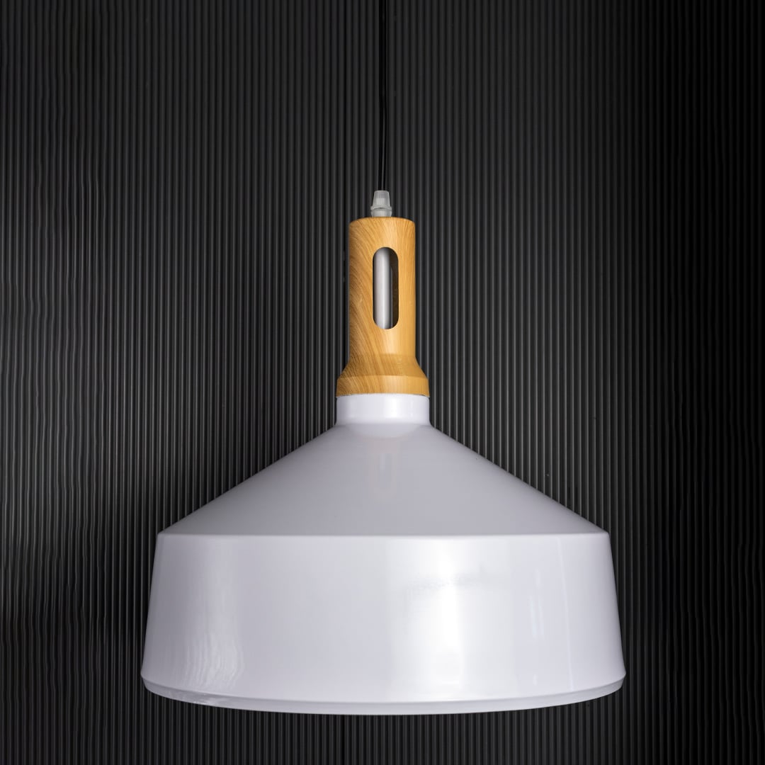 A white pendant light with a wooden top shown off against a dark black background emphasizing its sleek outline and smooth minimalist form.
