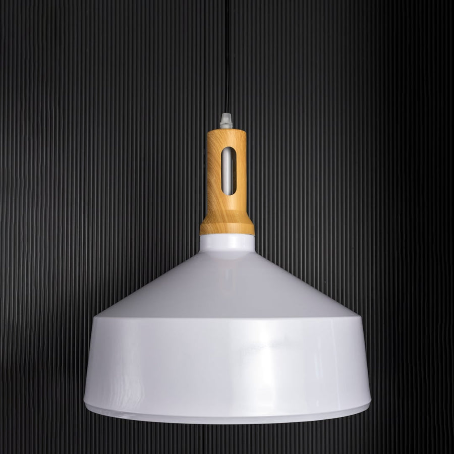 A white pendant light with a wooden top shown off against a dark black background emphasizing its sleek outline and smooth minimalist form.