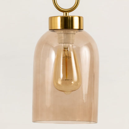 Closeup of smoked glass pendant light revealing metal frame and clear bulb design for a refined yet minimalistic lighting statement.