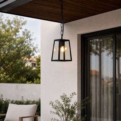 Black metal and glass outdoor hanging light for patio porch entrance and covered balcony with warm ambient lighting.