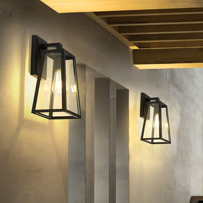 Black metal outdoor wall light with clear glass adding modern elegance to exterior walls for stylish home lighting decor.