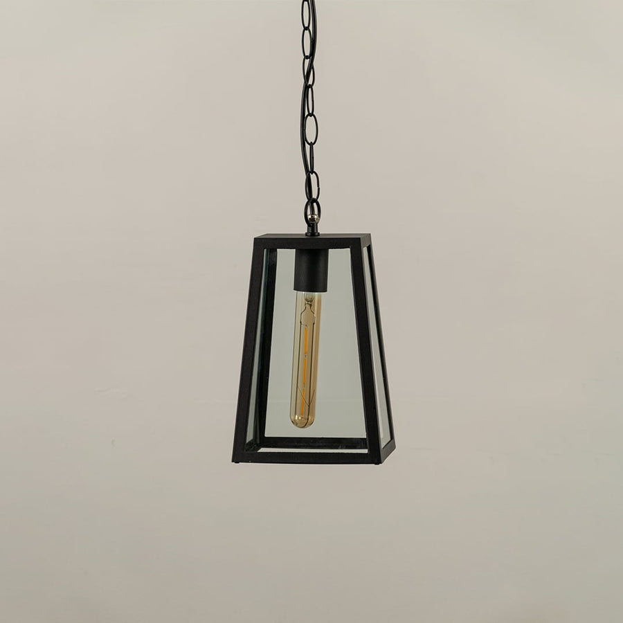 Black tapered hanging lantern on white background with light off displaying clear glass panels and minimal metal frame suitable for contemporary exterior decor.