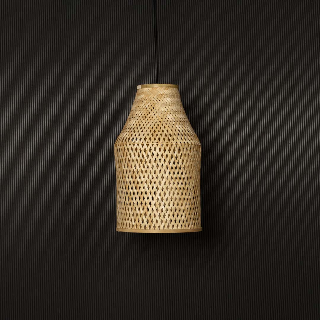 Bamboo pendant light bulb off on black background with tall cylindrical wicker shade design for rustic interiors.