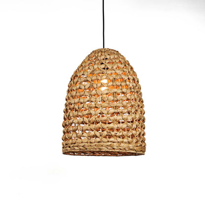 Natural rattan pendant light with rounded dome shape and tight woven texture hanging against soft neutral wall background for warm boho interior decor.