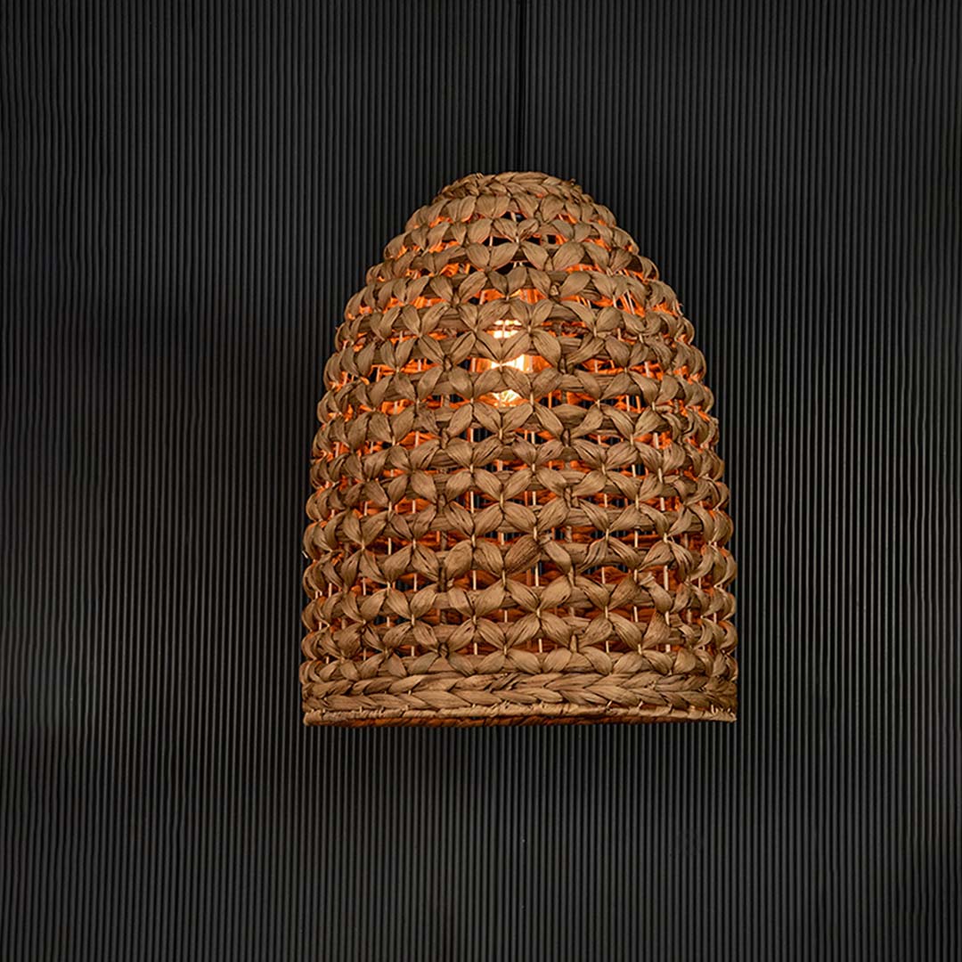Illuminated brown rattan pendant light with woven texture creating warm glow and elegant boho appeal.
