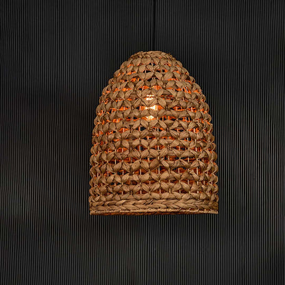 Illuminated brown rattan pendant light with woven texture creating warm glow and elegant boho appeal.