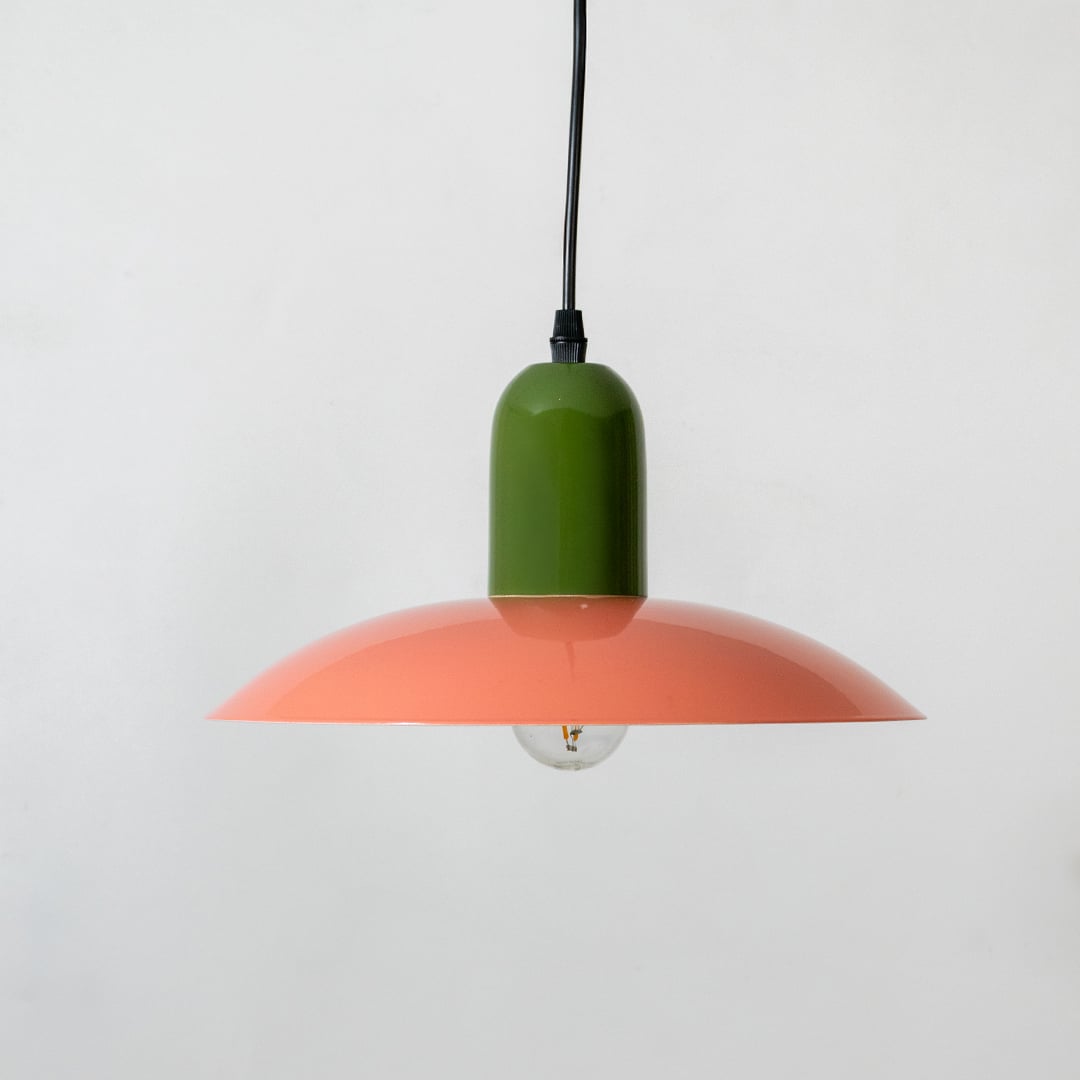 Orange and green metal pendant light with wide shade design for modern ceiling interiors.