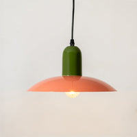 Orange and green metal pendant light with warm glow for kitchen island dining room ceiling decor.