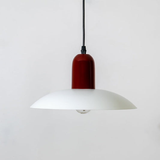 White metal pendant light with bulb off and deep red top displayed on white background for modern home interior decor.