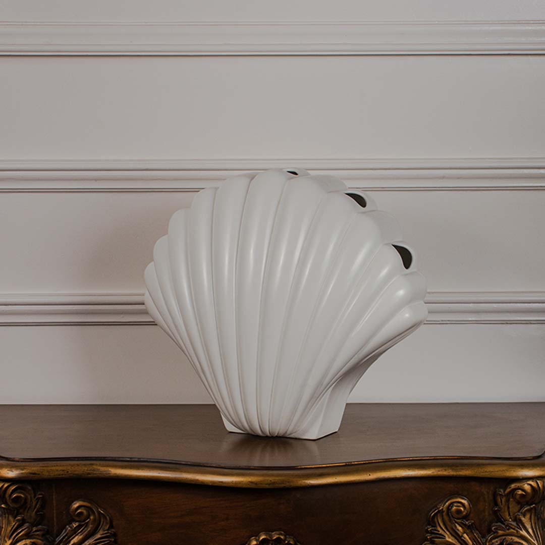 Modern white shell decor piece shown on a crisp white backdrop showcasing its smooth curved silhouette.