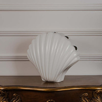 Modern white shell decor piece shown on a crisp white backdrop showcasing its smooth curved silhouette.