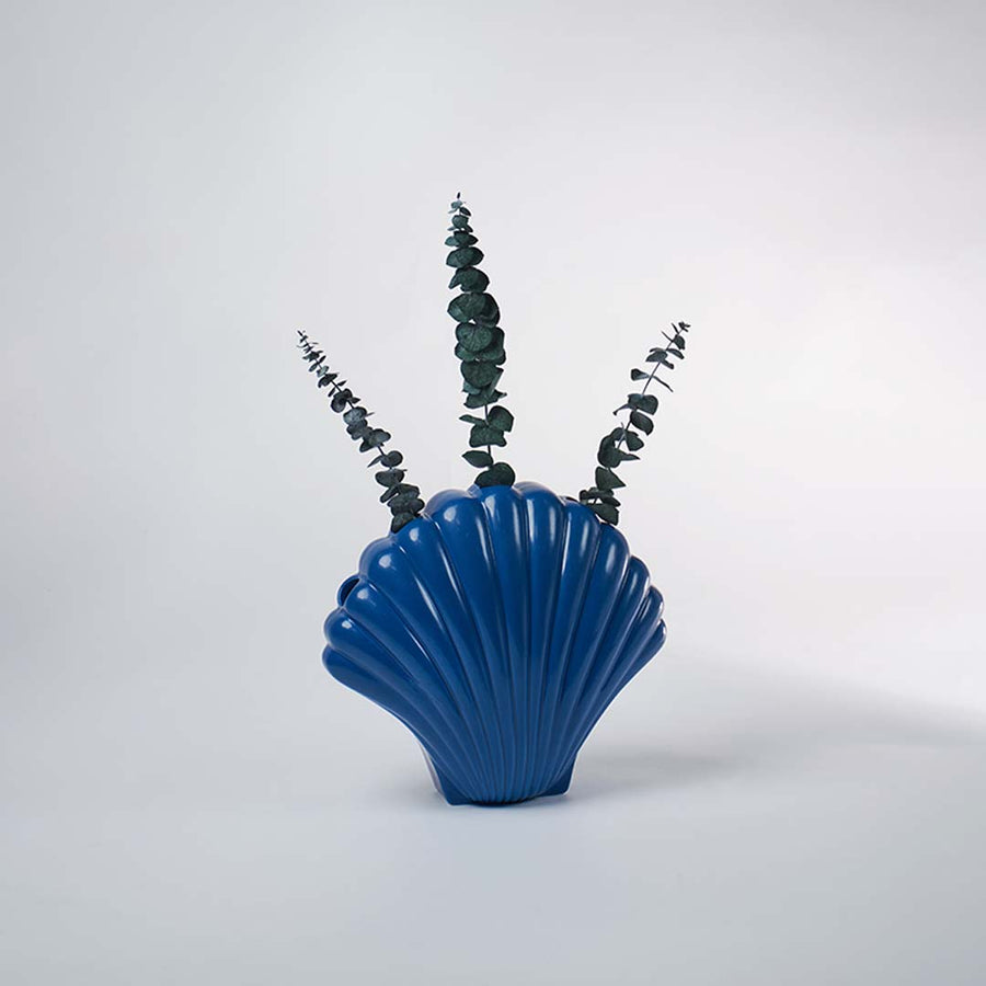 Elegant blue shell vase placed in a soft light setting creating a chic coastal accent for stylish modern home decor.