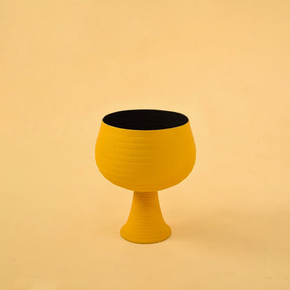 Yellow metal pedestal bowl decor on a clean white background highlighting its bold modern textured design for home styling.