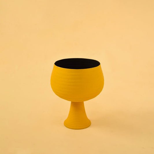 Yellow metal pedestal bowl decor on a clean white background highlighting its bold modern textured design for home styling.