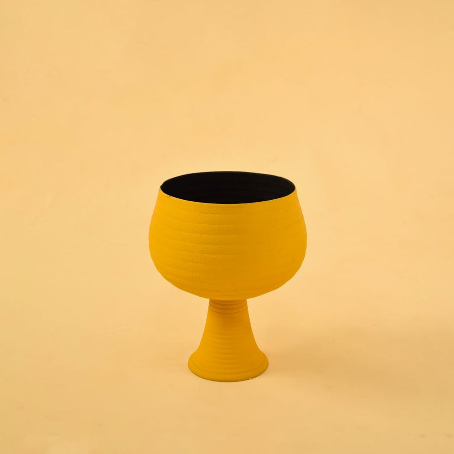 Yellow metal pedestal bowl decor on a clean white background highlighting its bold modern textured design for home styling.