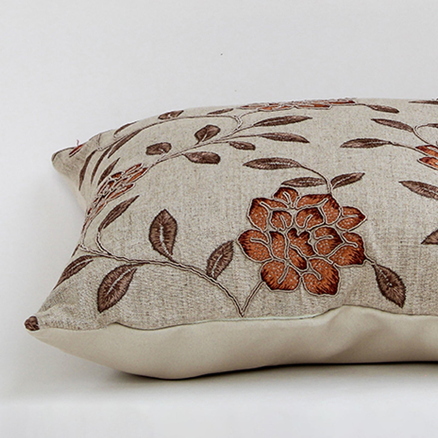 White cotton cushion cover with brown floral print showcasing soft cotton fabric texture and concealed zipper finish.