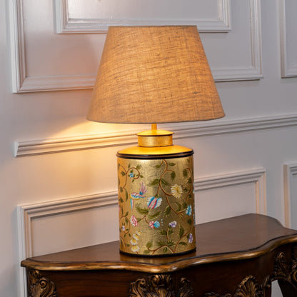 Oriental Orchard gold table lamp on white background glowing warmly highlighting intricate design and luxurious interior decor appeal.