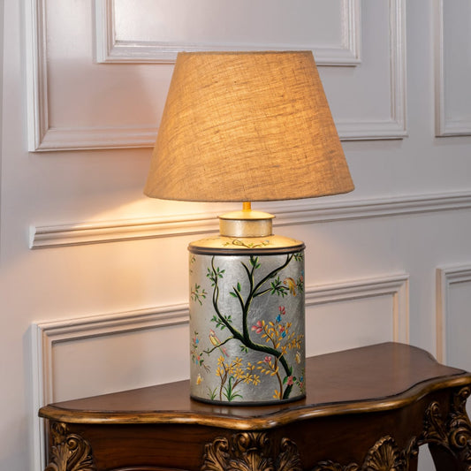 Oriental Orchard silver table lamp turned on against white background offering subtle glow refined detailing and modern interior elegance.