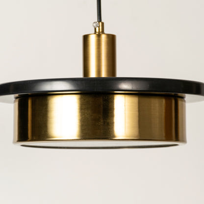 Black marble and gold metal pendant light illuminated to highlight contemporary ceiling lighting with premium elegance.
