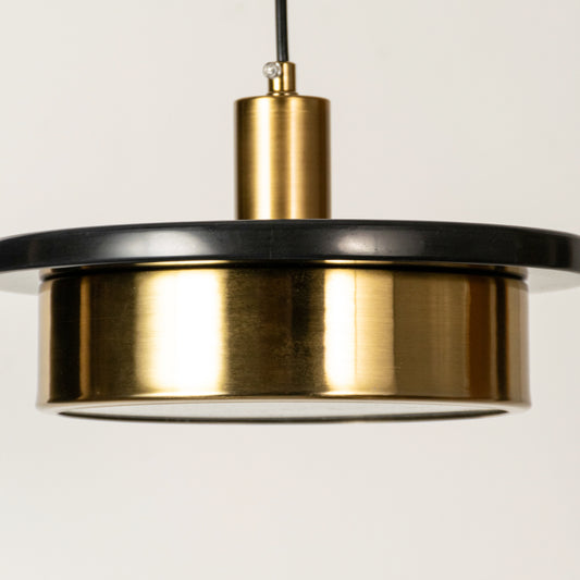 Black marble and gold metal pendant light illuminated to highlight contemporary ceiling lighting with premium elegance.

