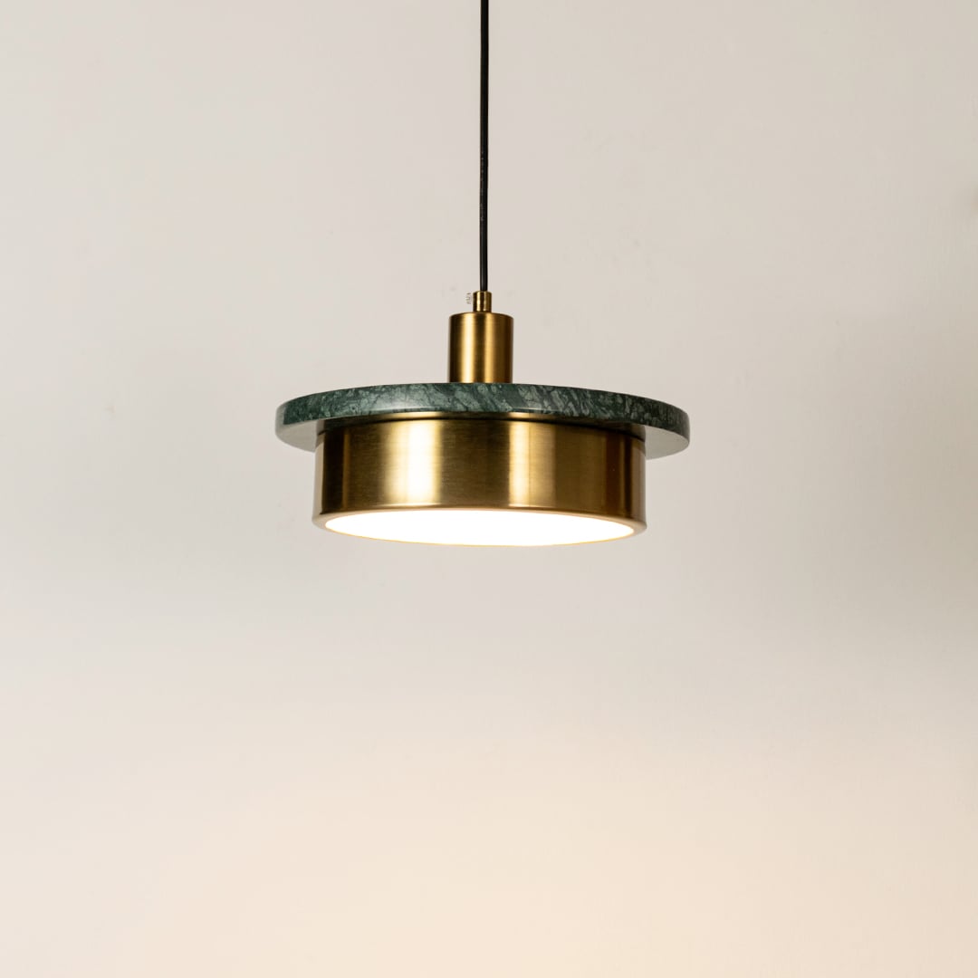 Gold metal pendant light illuminated with sleek cylindrical design highlighting contemporary hanging light craftsmanship.