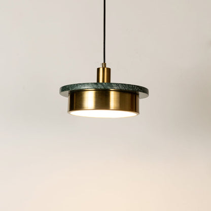 Gold metal pendant light illuminated with sleek cylindrical design highlighting contemporary hanging light craftsmanship.
