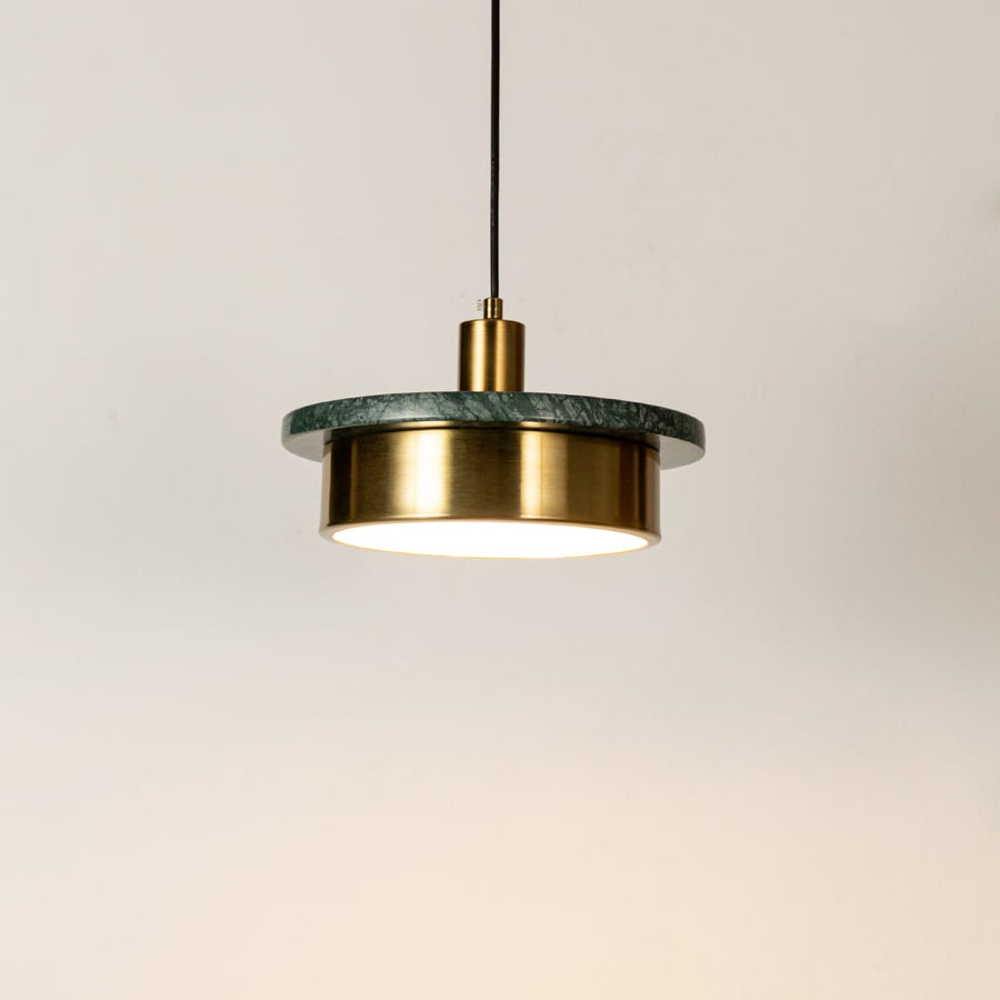 Gold metal pendant light illuminated with sleek cylindrical design highlighting contemporary hanging light craftsmanship.
