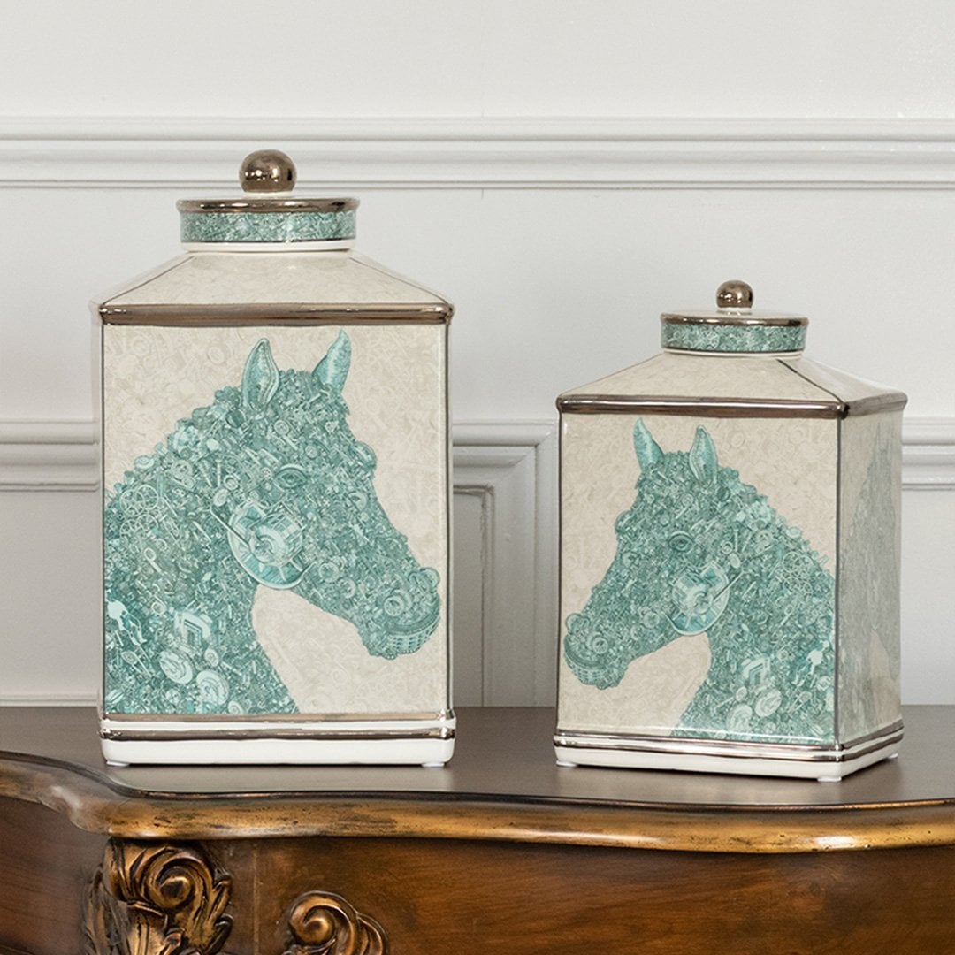 White ceramic jars with green horse artwork placed neatly on a wooden console table adding an elegant decorative accent that enhances the interior décor style.