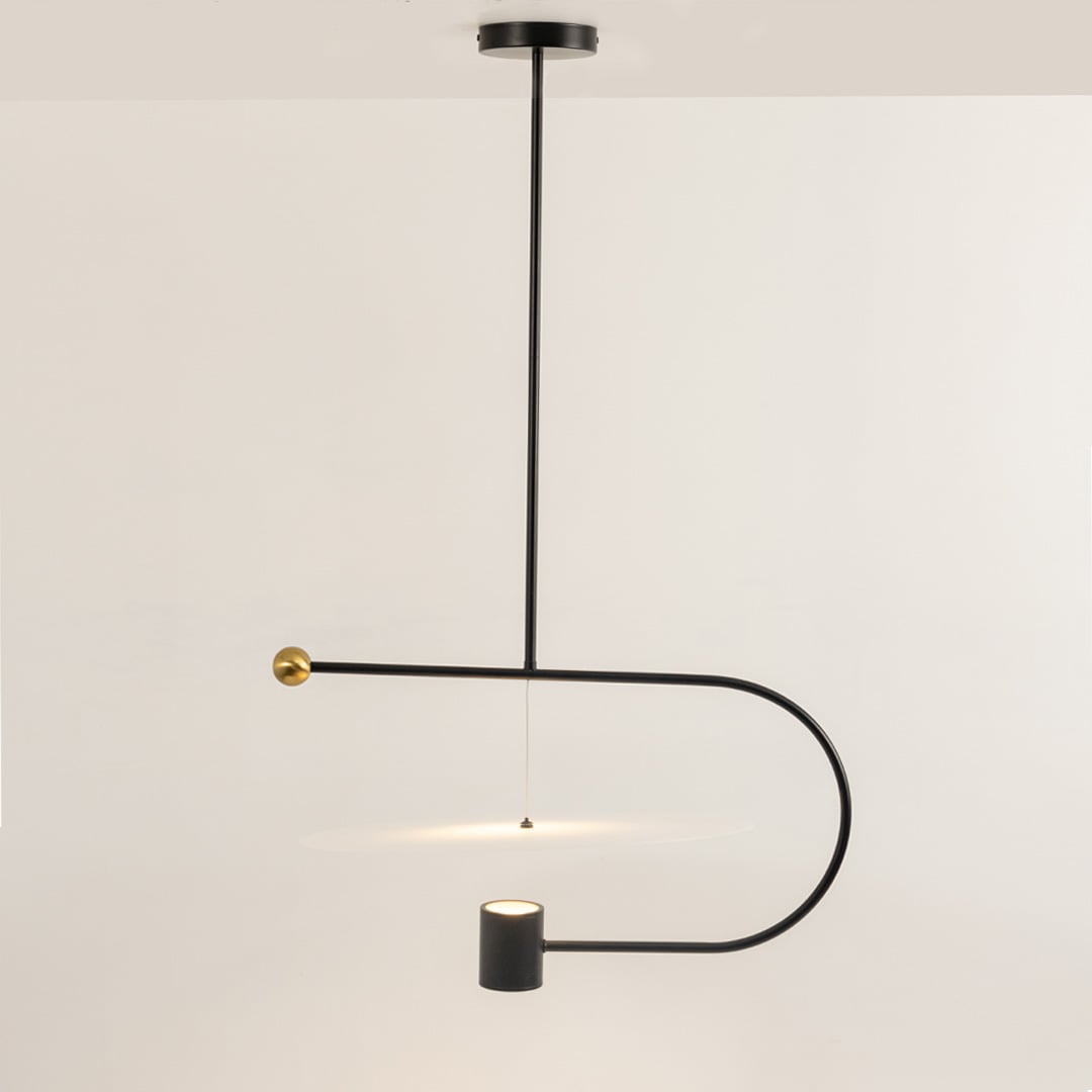 Black metal pendant linear light with curved sculptural form glowing softly against a clean white background showcasing refined modern interior home decor lighting style.