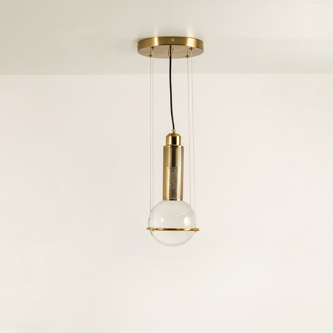 Pendant light with frosted glass globe and metal cylinder shown switched off on a clean white background highlighting its modern sculptural shape for interior decor styling.
