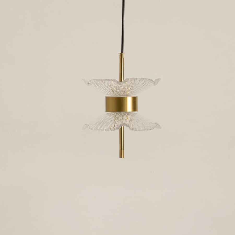 Gold pendant light with clear textured glass shades shown on a bright white background with lights turned off for a minimal look.