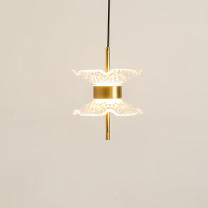 Gold pendant light with double textured glass shades glowing softly on a clean white background for modern home lighting decor.