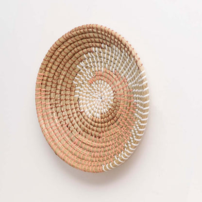 Side view of handwoven wall basket decor made of rustic natural fiber with boho style for wall decoration.