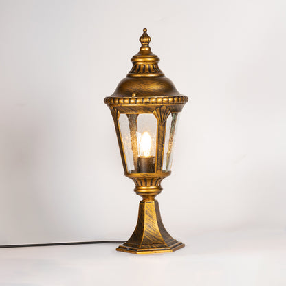Antique gold outdoor gate light with glowing glass shade for luxury exterior decor styling use.