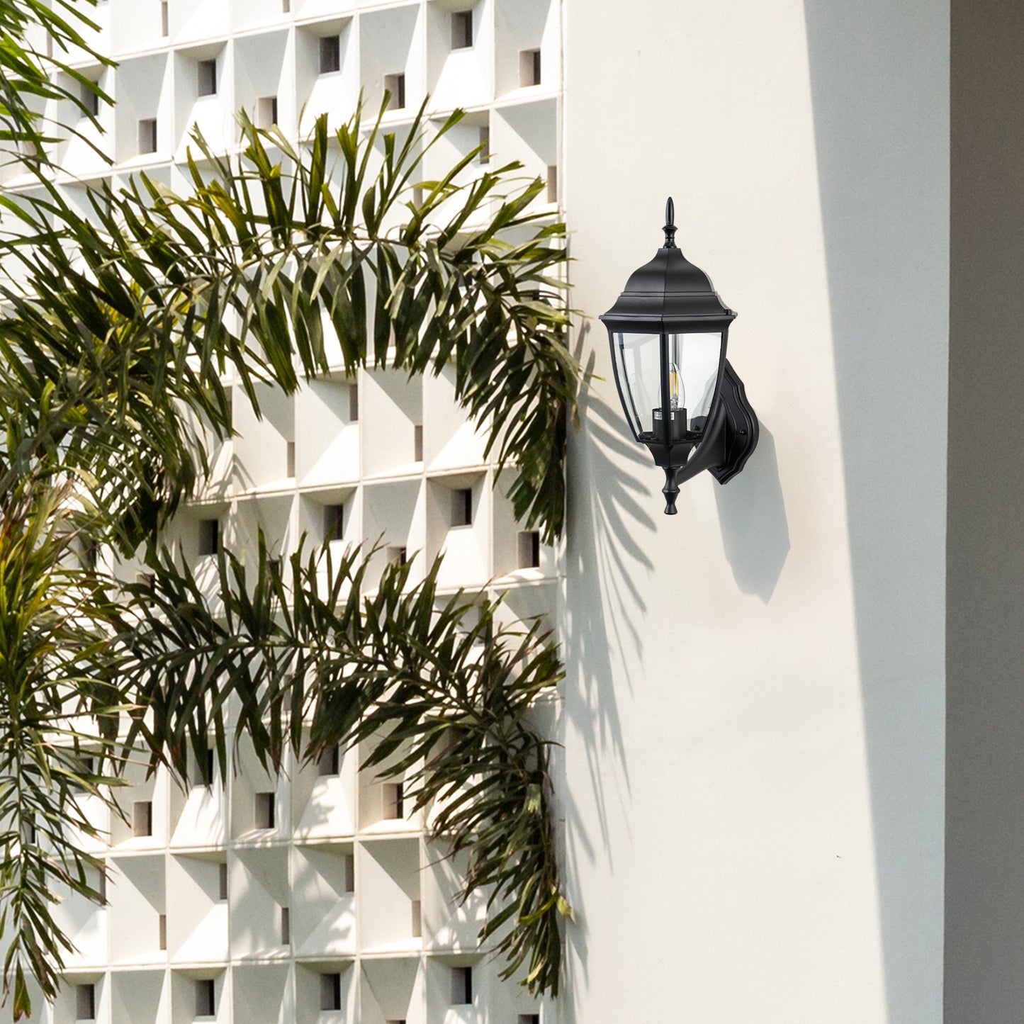 Black metal outdoor wall light lifestyle image on modern exterior wall for elegant patio lighting decor.