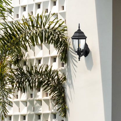 Black metal outdoor wall light lifestyle image on modern exterior wall for elegant patio lighting decor.