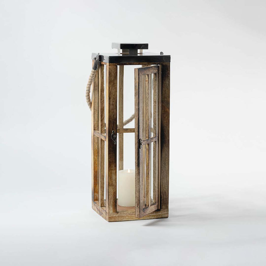 Rustic wooden lantern with clear glass panels and black metal top for farmhouse tabletop decor styling.