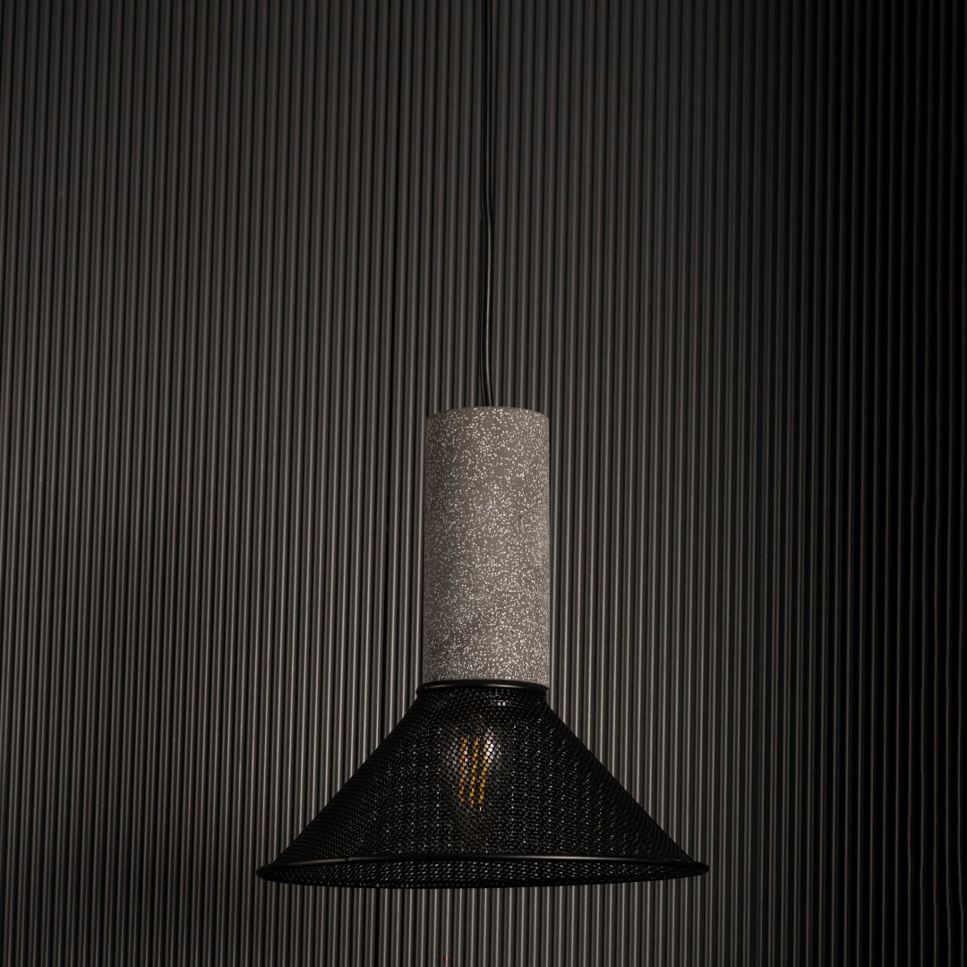 Arlo Cone Mesh pendant light off against a dark background highlighting its warm glow and geometric form.