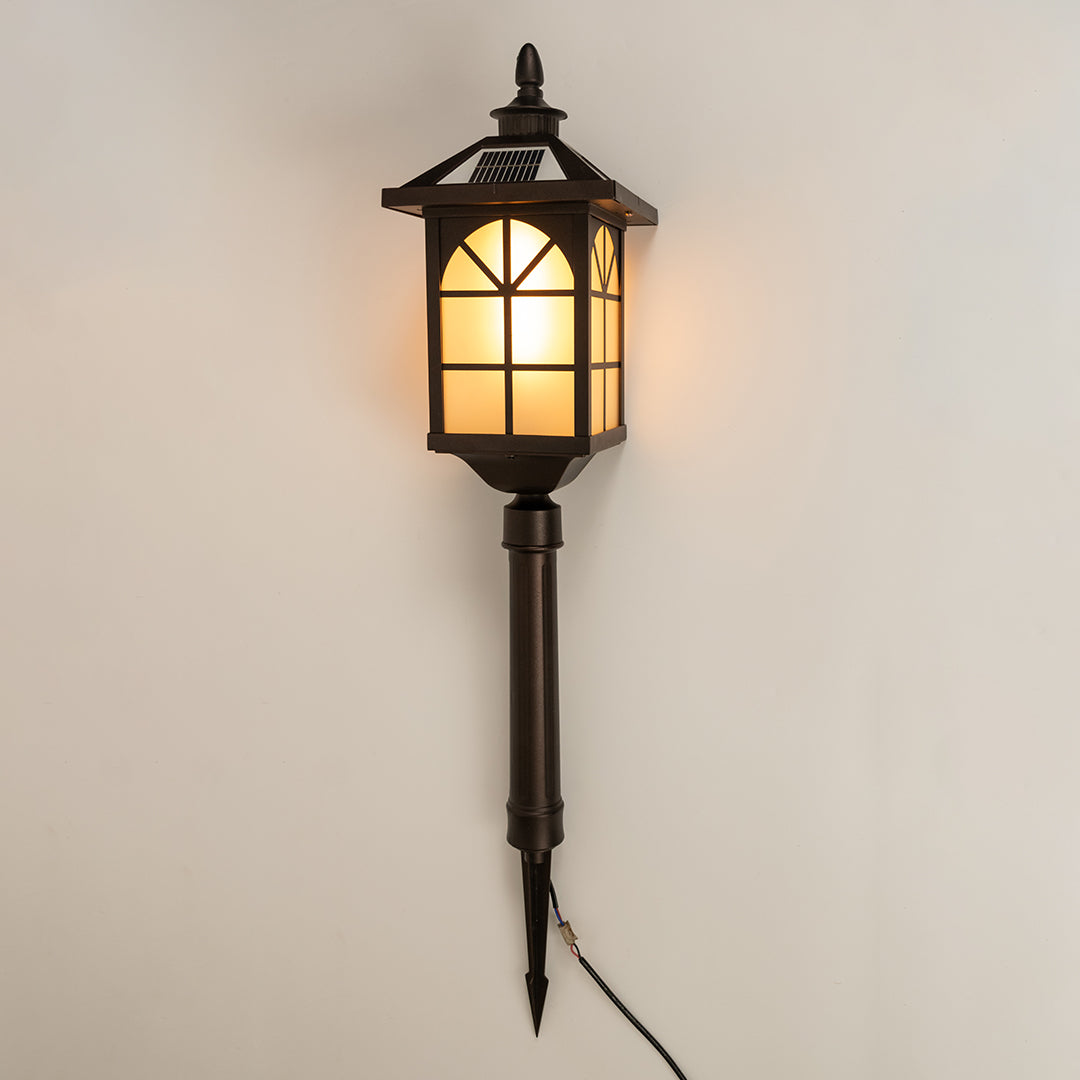 Vintage black outdoor wall light with warm glowing panels for elegant exterior decor styling use.
