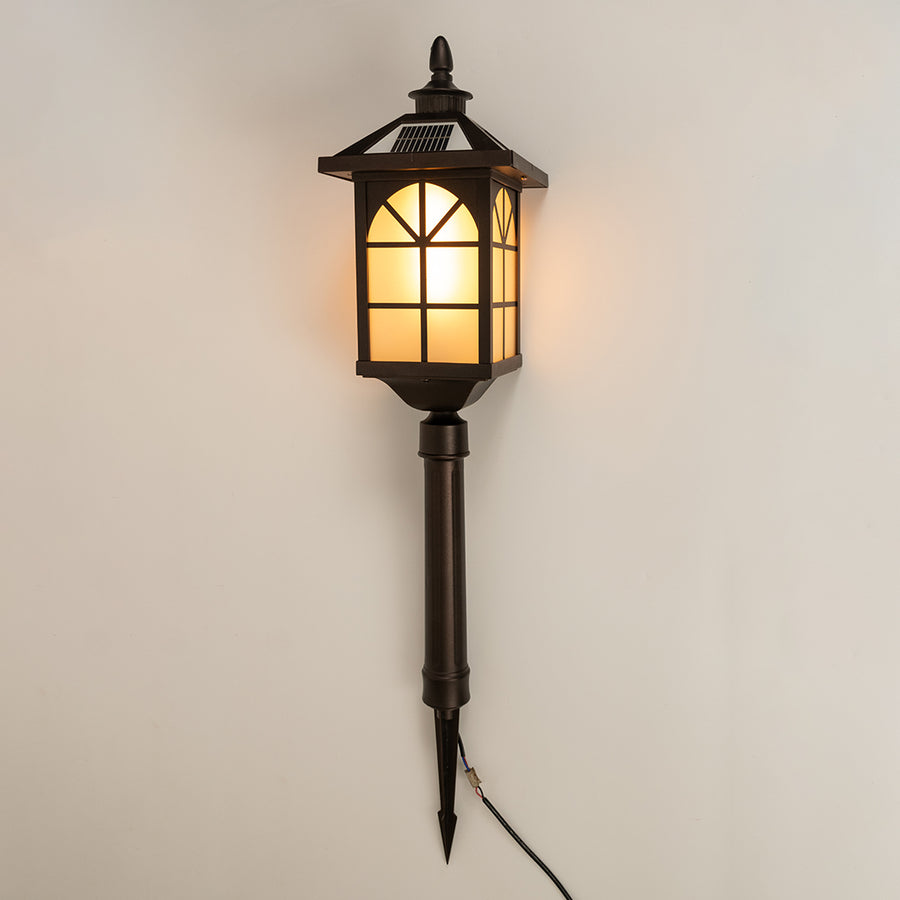 Vintage black outdoor wall light with warm glowing panels for elegant exterior decor styling use.