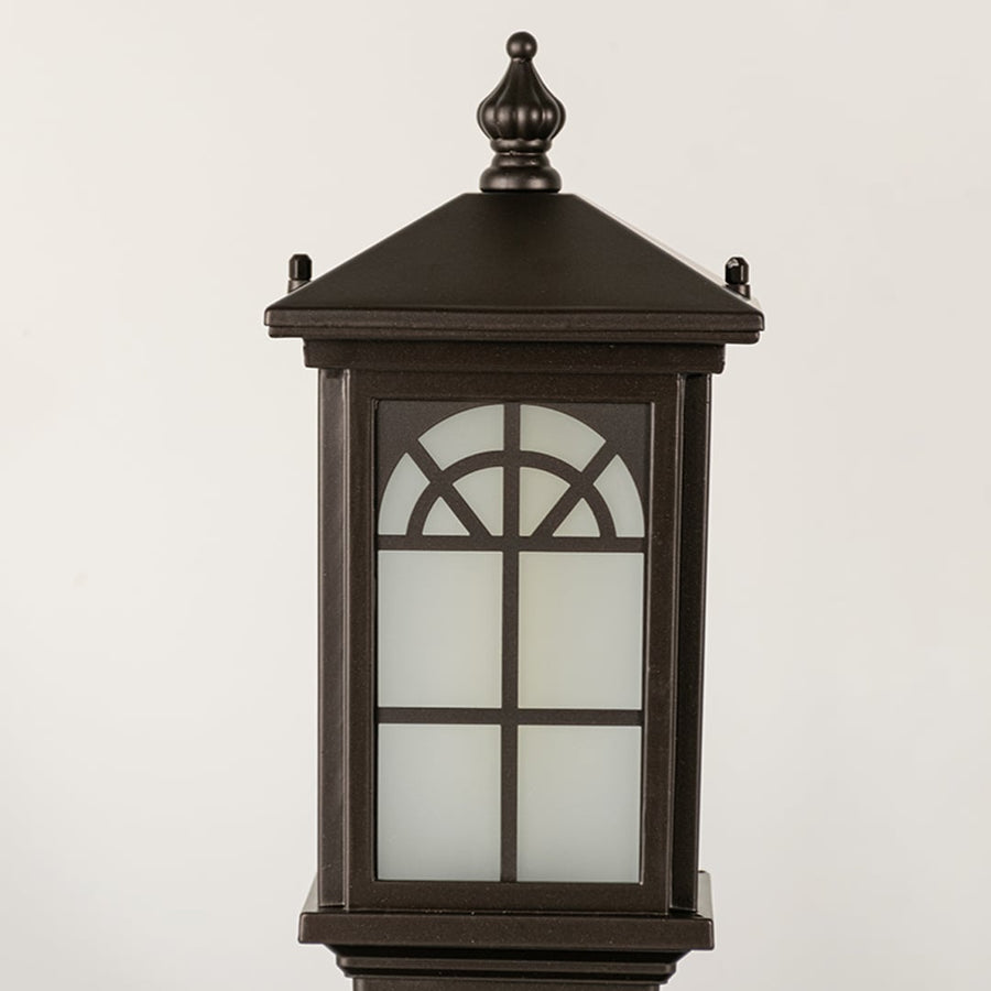 Black outdoor lantern Closeup seeded glass Light On showing the warm ambient glow and decorative pebbled glass panels detail.