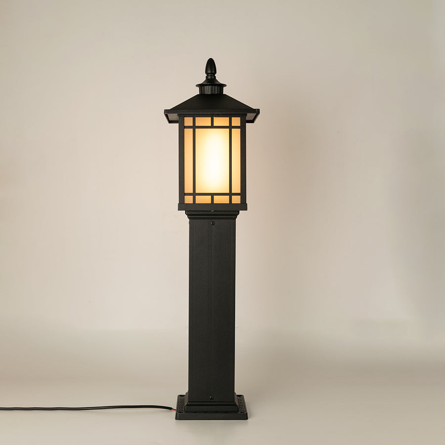 Black outdoor gate light with frosted glowing panels for stylish modern exterior decor use.