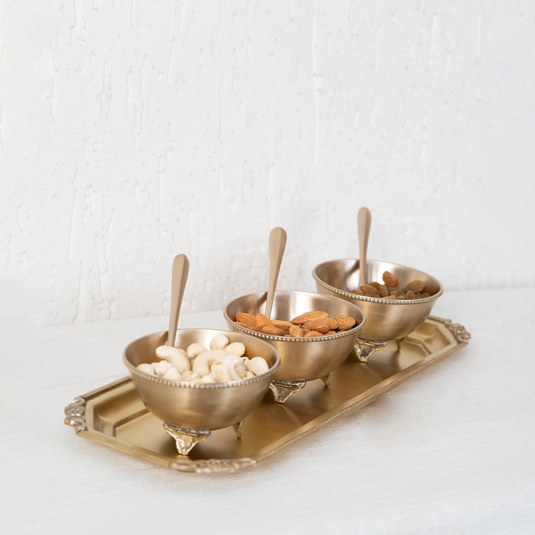 Single brass spoon with smooth finish and traditional shape displayed individually on white background surface.