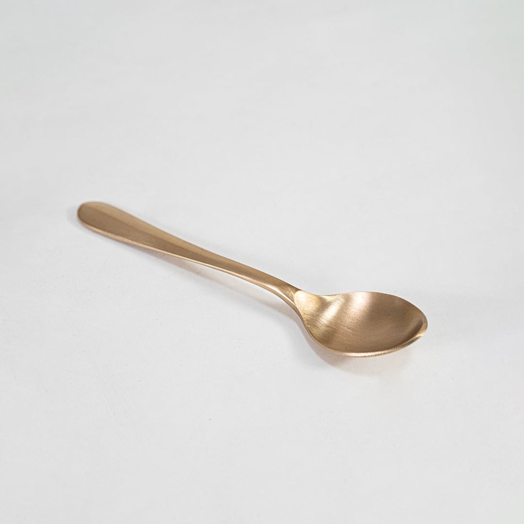 Small footed brass bowl with smooth round finish shown alone on white background for detailed view.