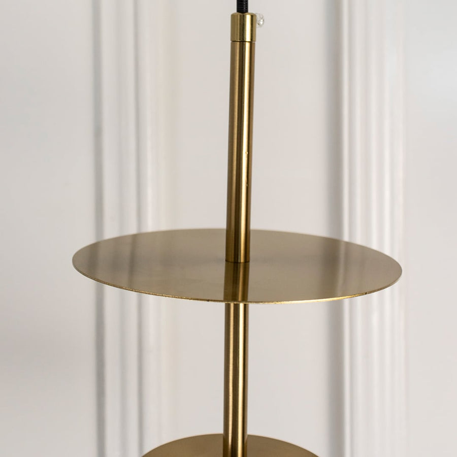 Closeup of gold metal pendant light with flat disc shade showcasing premium craftsmanship.