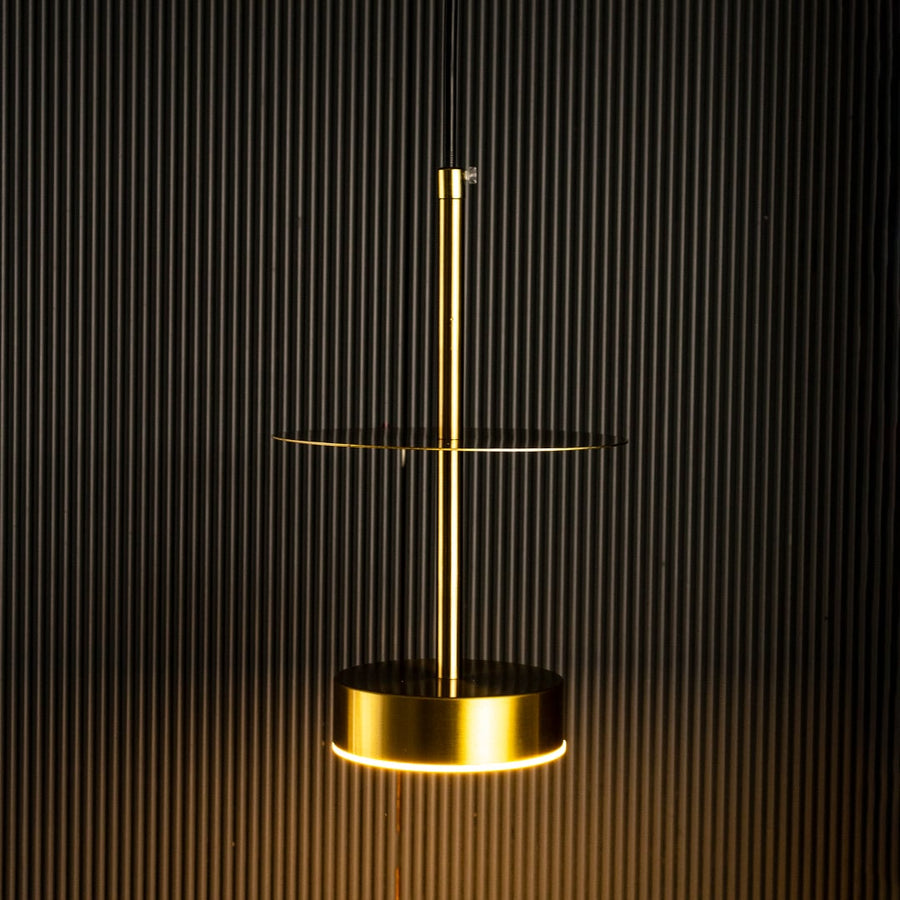Closeup of halo brass pendant light turned off showing fine brass texture and circular pendant detailing.