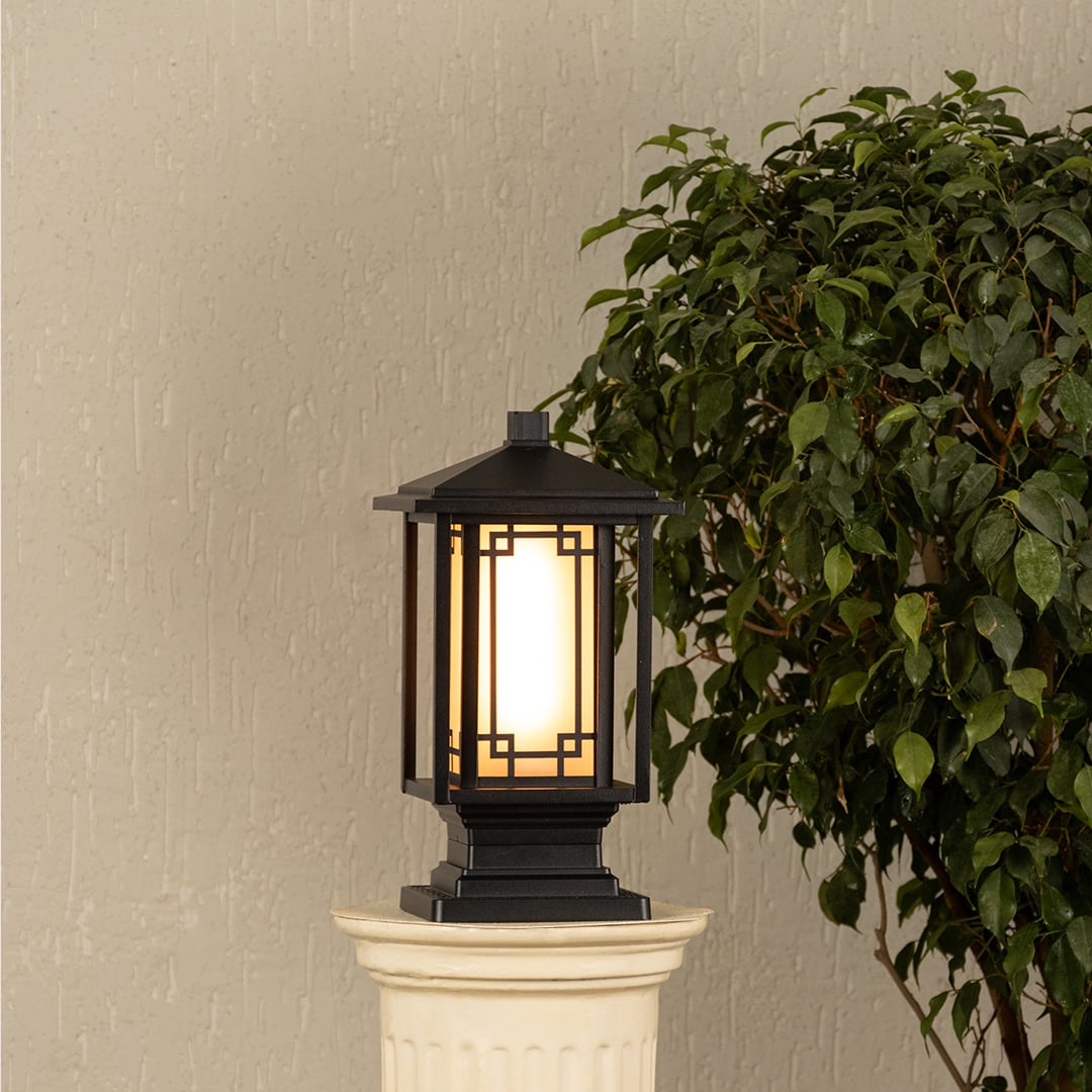Black outdoor gate light with warm ambient glow for stylish exterior decor styling use.