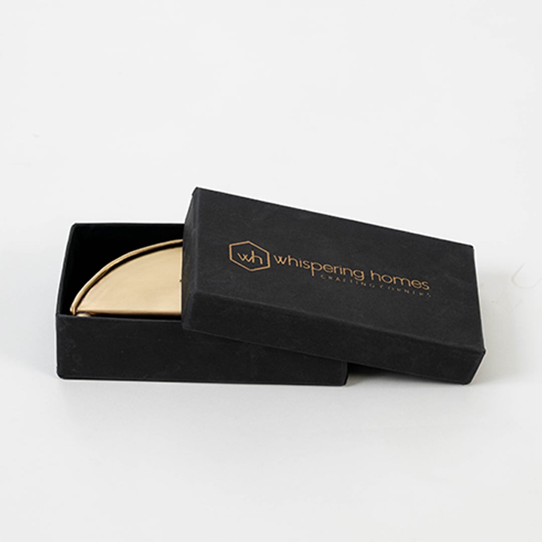 Brass napkin holder packed neatly inside premium black box with soft inserts ideal for gifting and protective storage.